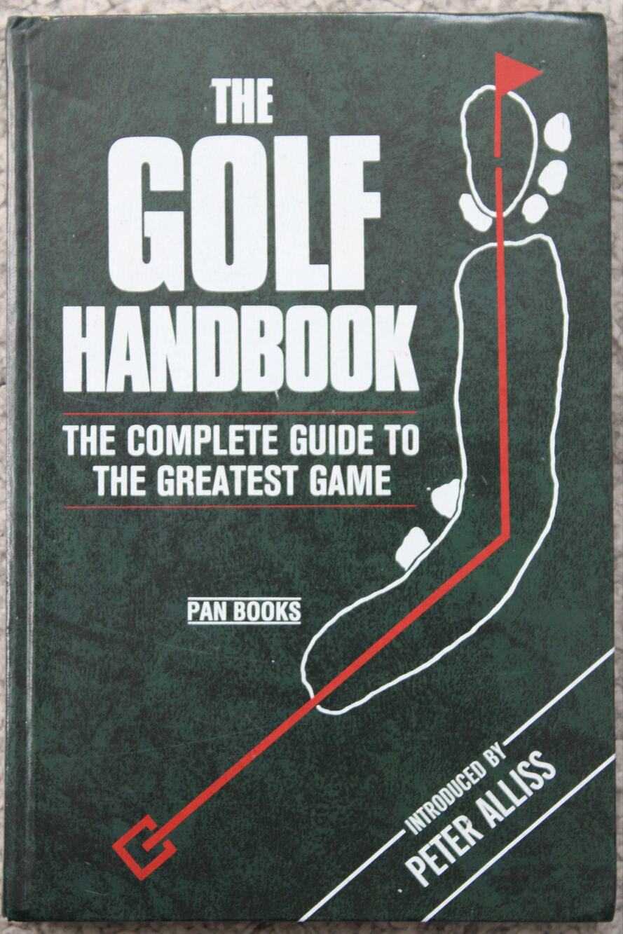 The golf handbook paperback book from Pan Books with dark green cover